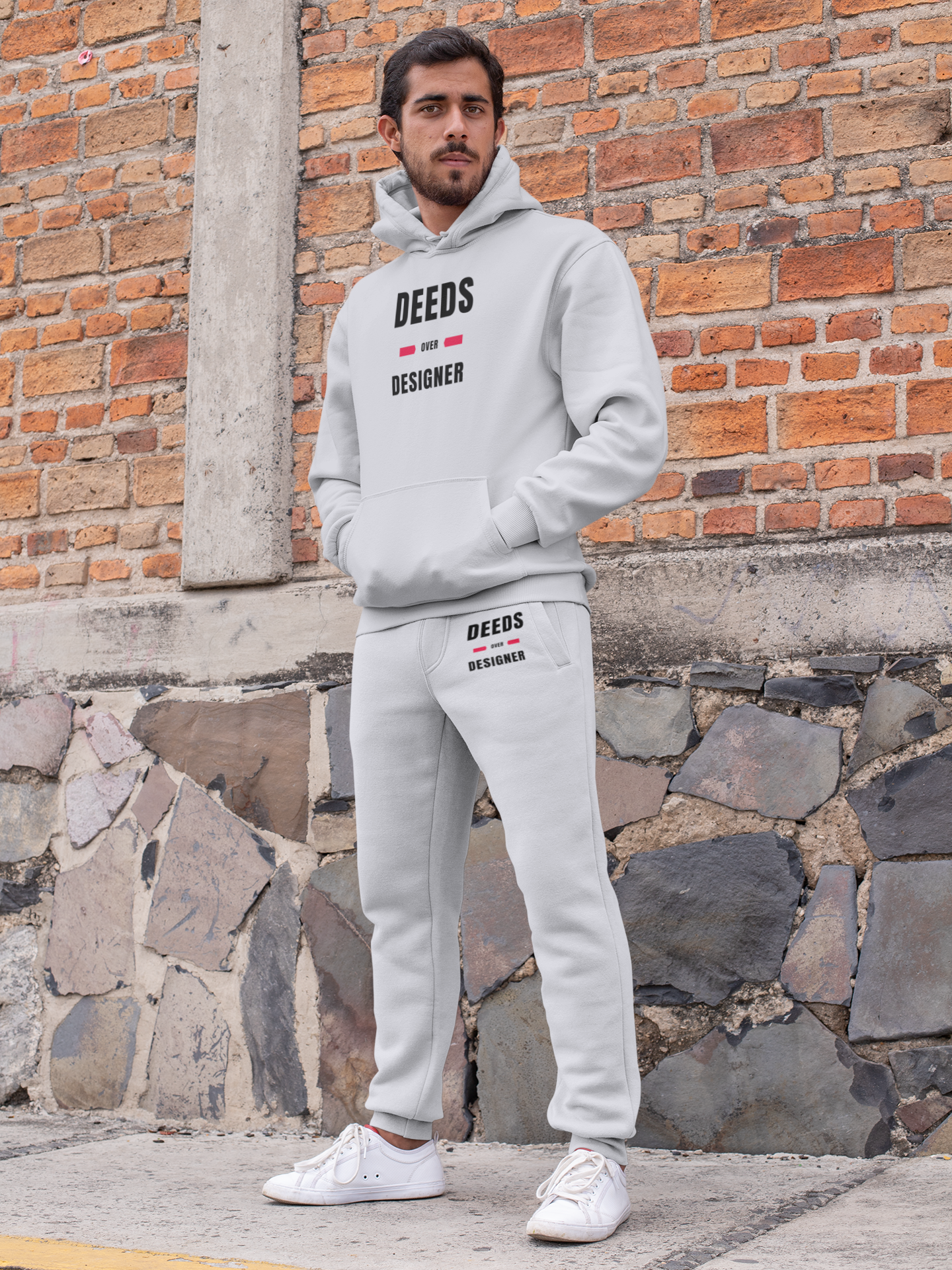 https://www.deedsoverdesignerbrand.com/cdn/shop/products/pullover-hoodie-mockup-featuring-a-man-with-sweatpants-by-a-brick-wall-29847.png?v=1675233240&width=1445